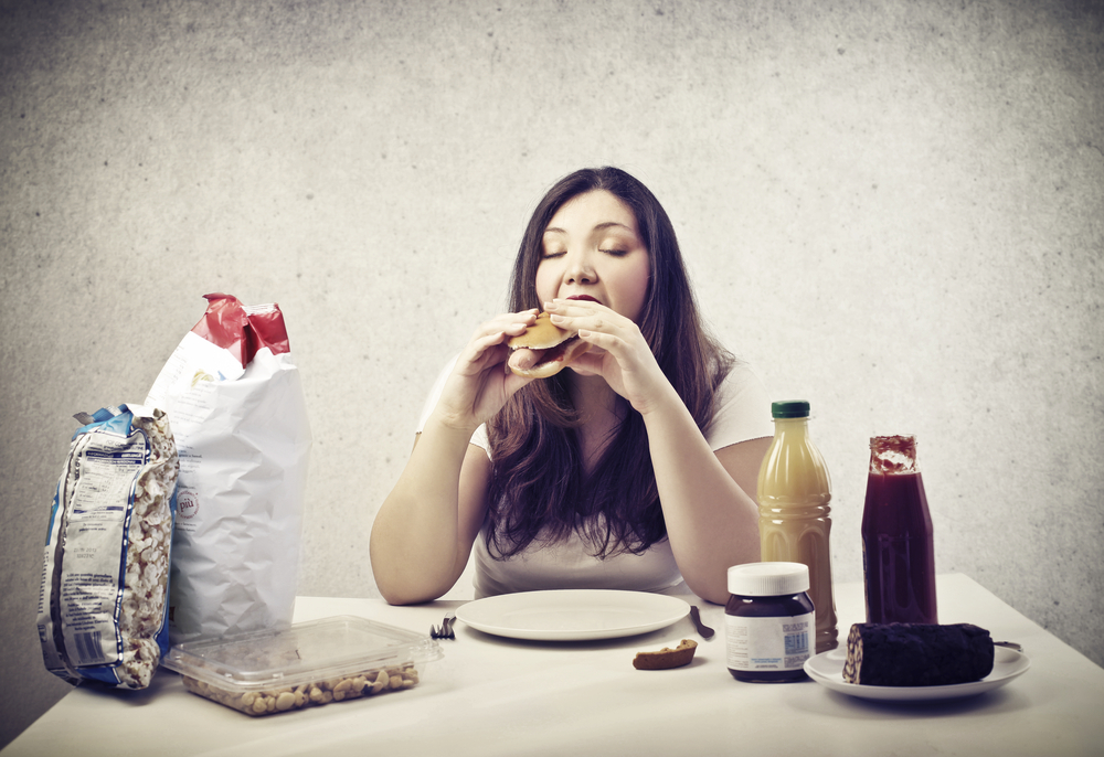 overweight woman eating junk food